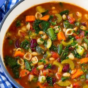 A pot of Olive Garden minestrone soup loaded with vegetables, beans and pasta.