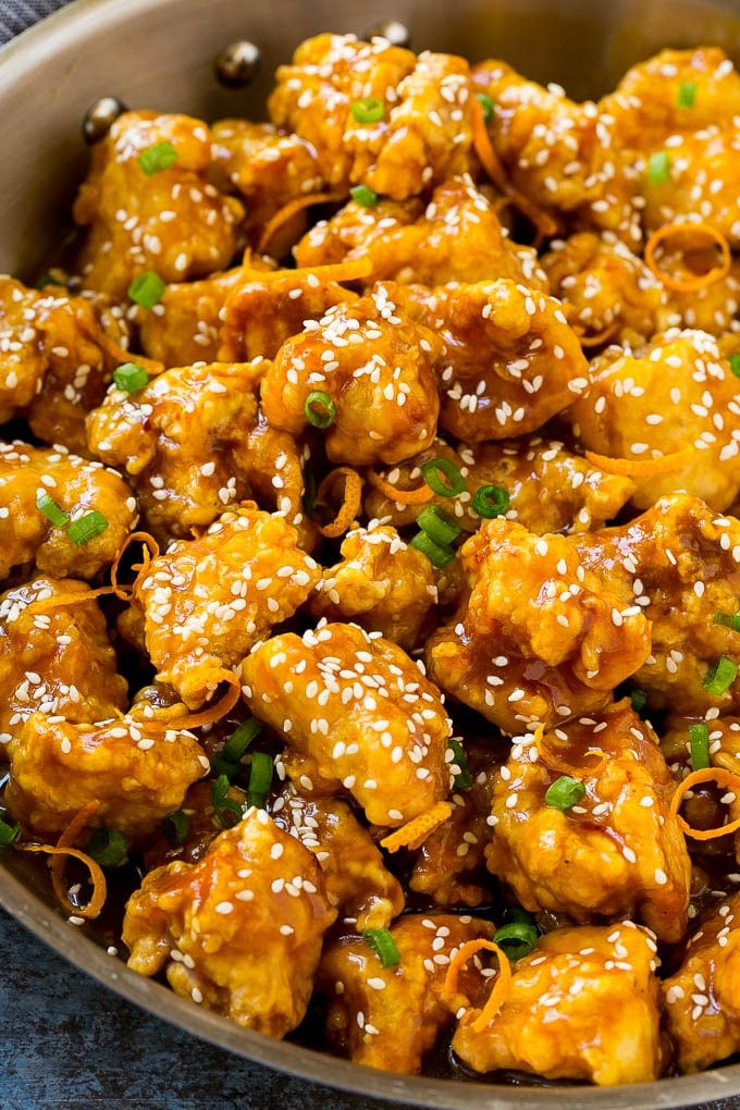 Orange Chicken Recipe | Chinese Orange Chicken | Panda Express Orange Chicken #orange #chicken #takeout #chinesefood #dinner #sadud Orange chicken in a skillet with crispy chicken, sesame seeds, orange zest and green onions.