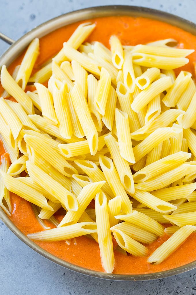 This Penne alla Vodka is tender penne pasta tossed in a rich and delicious tomato, vodka and cream sauce. Add a sprinkling of parmesan cheese and you'll have a restaurant quality meal in the comfort of your own home. Penne pasta in a creamy tomato vodka sauce.