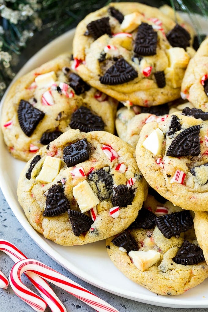 Oreo Peppermint Cookies Recipe | Candy Cane Cookies | Oreo Cookies #oreo #peppermint #cookies #baking #Christmas #sweets #sadud A plate of Oreo peppermint cookies filled with white chocolate and candy canes.
