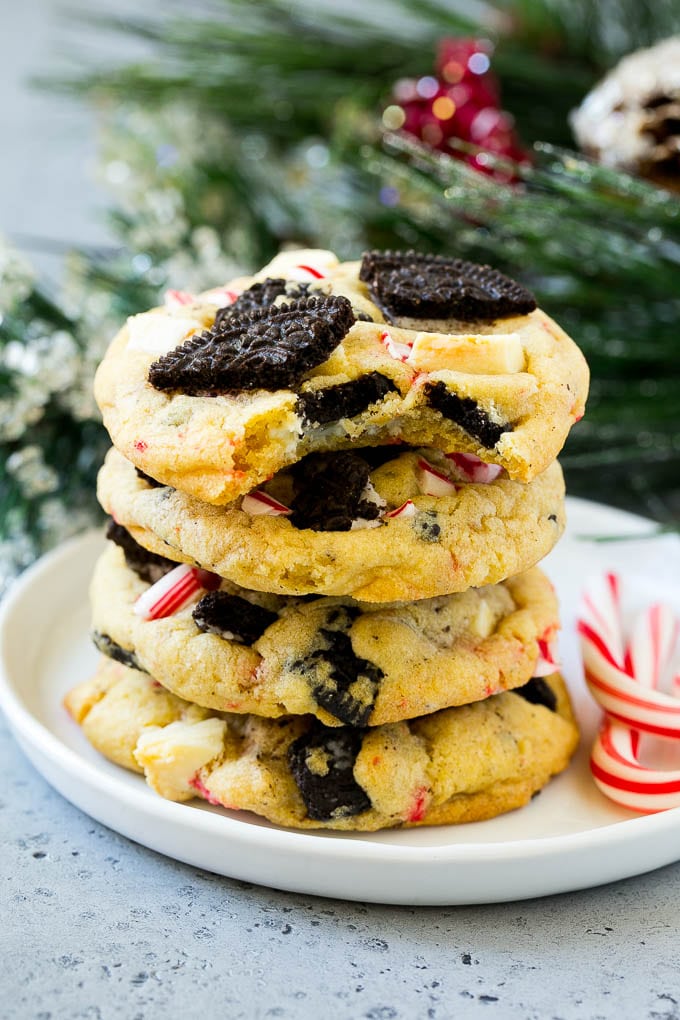 Oreo Peppermint Cookies Recipe | Candy Cane Cookies | Oreo Cookies #oreo #peppermint #cookies #baking #Christmas #sweets #sadud A stack of Oreo peppermint cookies on a plate, garnished with candy canes.