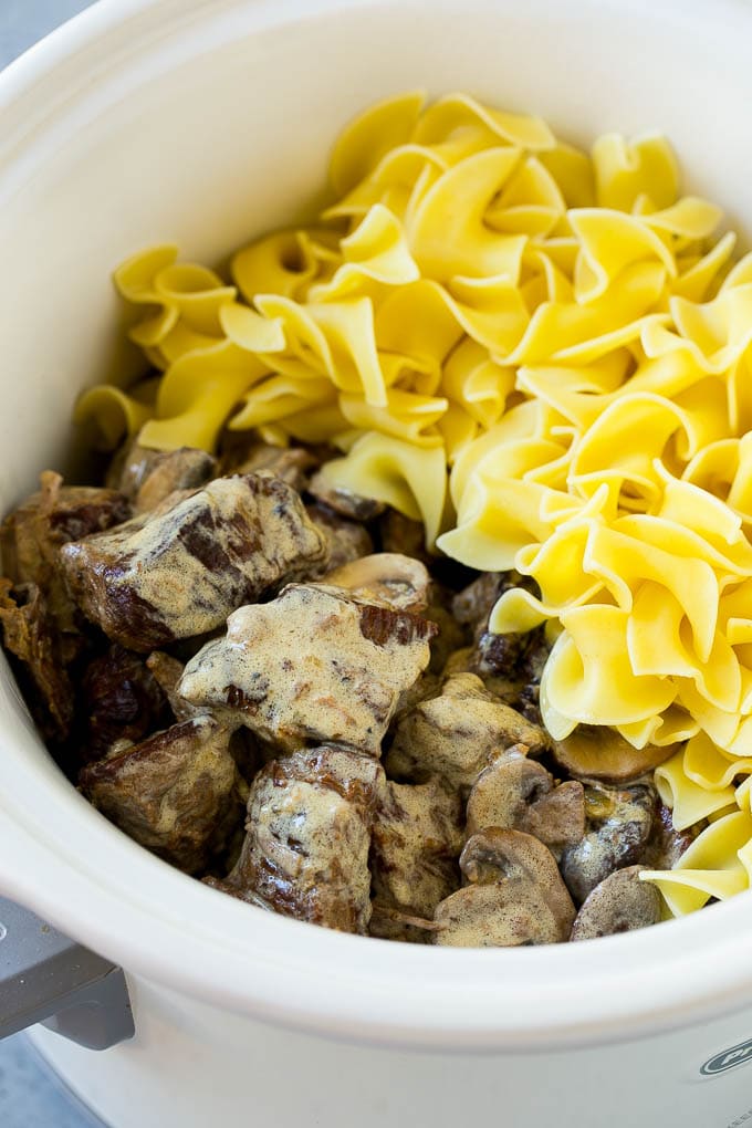 Slow Cooker Beef Stroganoff Recipe | Crock Pot Beef Stroganoff | Beef Recipe #slowcooker #crockpot #beef #mushrooms #pasta #dinner #sadud Beef in a creamy sauce and egg noodles in a slow cooker.