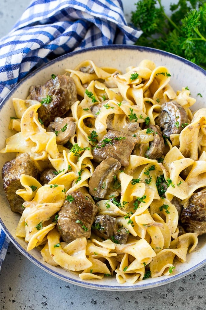 Slow Cooker Beef Stroganoff Recipe | Crock Pot Beef Stroganoff | Beef Recipe #slowcooker #crockpot #beef #mushrooms #pasta #dinner #sadud A bowl of slow cooker beef stroganoff with egg noodles.