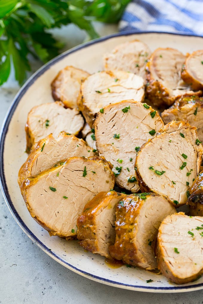 Slow Cooker Pork Tenderloin Recipe | Crock Pot Pork Tenderloin | Easy Pork Tenderloin #slowcooker #crockpot #pork #dinner #sadud Sliced slow cooker pork tenderloin on a plate.