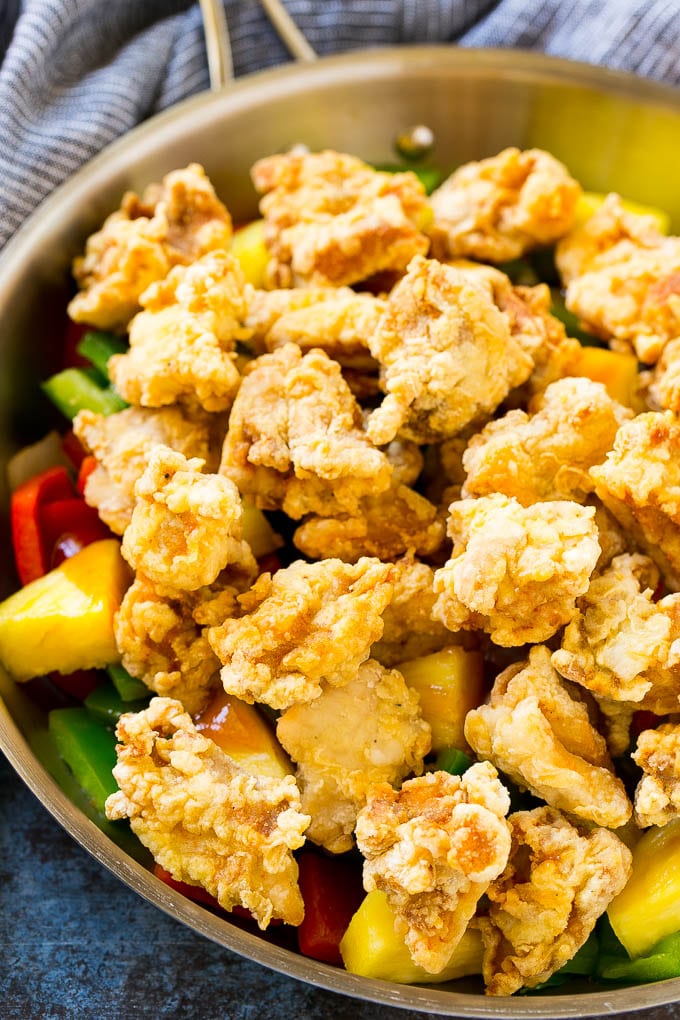Sweet and Sour Chicken Recipe | Chinese Food Copycat Recipe | Chicken with Pineapple #chicken #chinesefood #pineapple #stirfry #takeout #dinner #sadud Fried chicken pieces in a pan with pineapple, peppers and onions.