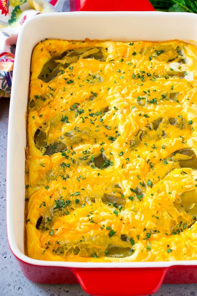 Chile Relleno Casserole Recipe | Baked Chile Rellenos | Mexican Casserole #casserole #chiles #mexican #cheese #dinner #sadud A dish of chile relleno casserole topped with cheddar cheese and chopped cilantro.