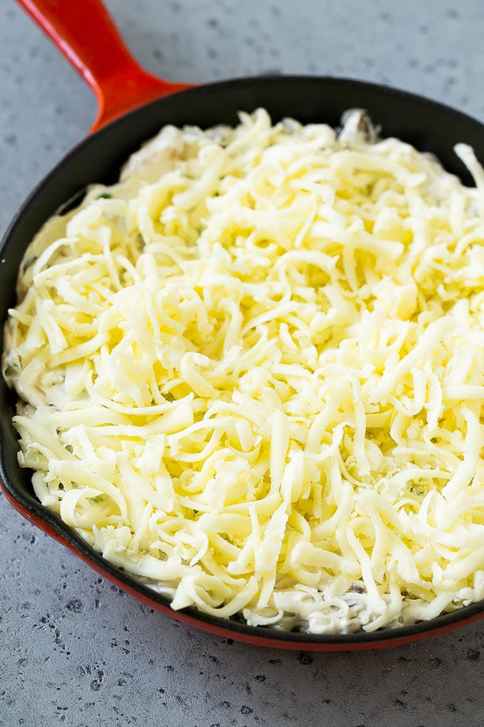 Philly Cheesesteak Dip Recipe | Cheesy Dip | Baked Cheese Dip #steak #dip #appetizer #cheese #sadud Philly cheesesteak dip with shredded cheese on top, waiting to go into the oven.