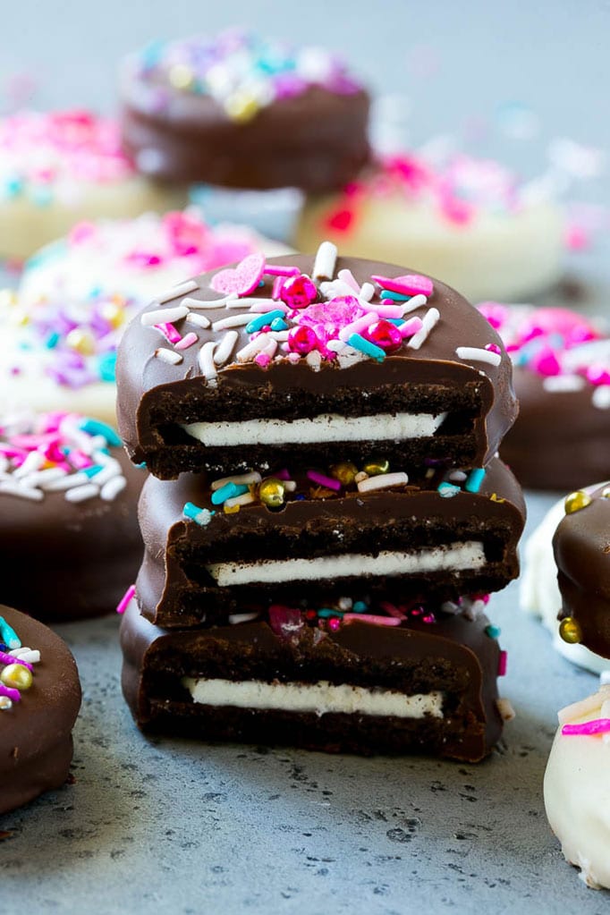 Chocolate Covered Oreos Recipe | Oreo Cookies | Chocolate Dipped Oreos #oreo #cookies #chocolate #sprinkles #dessert #sadud Three chocolate covered Oreos stacked on top of each other.