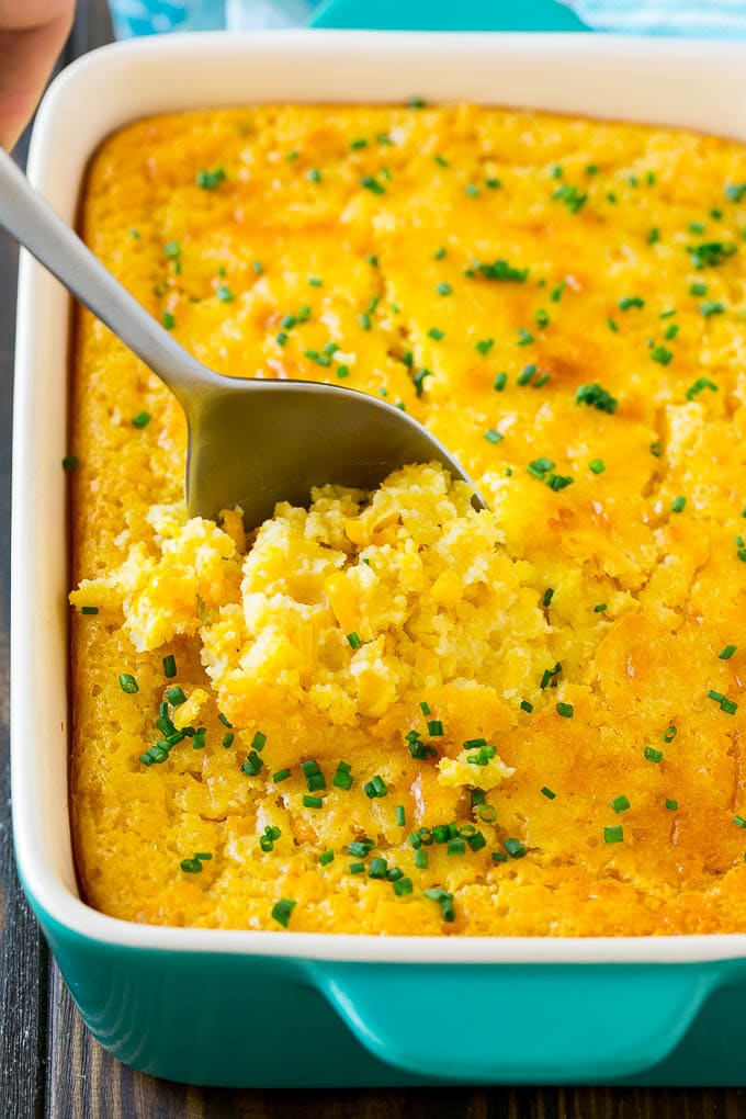 Corn Pudding Recipe | Corn Casserole | Corn Side Dish #corn #pudding #casserole #sidedish #thanksgiving #dinner #sadud A pan of corn pudding with a serving spoon in it.