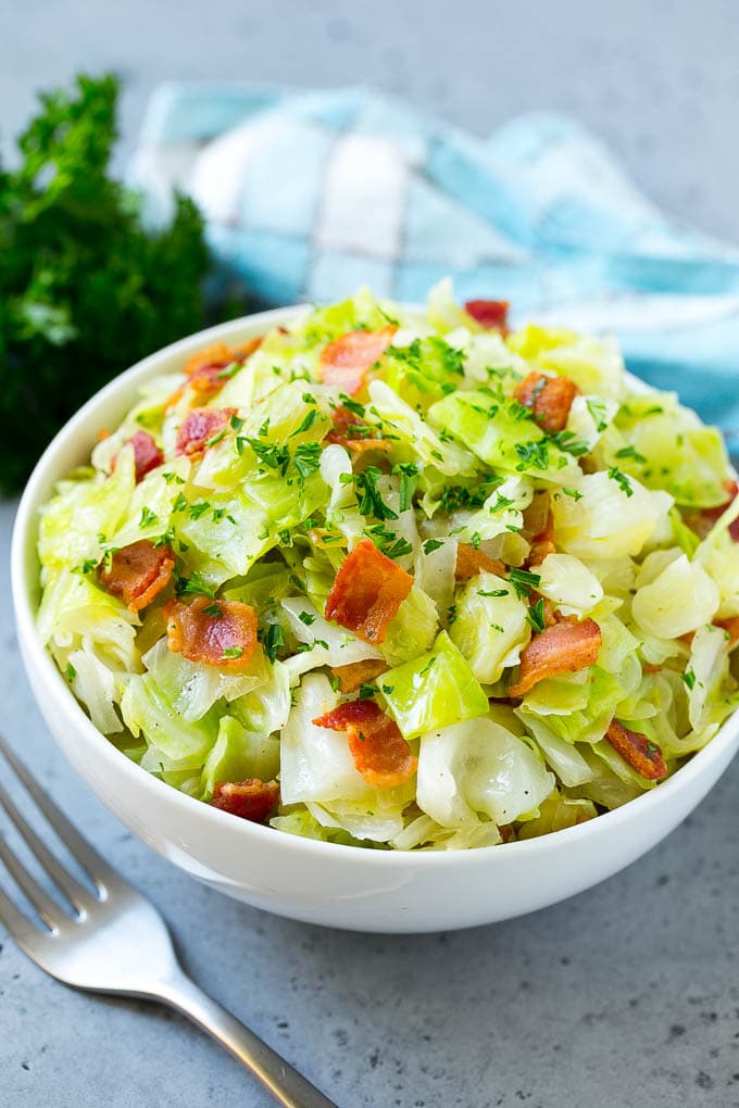 Fried Cabbage Recipe | Cabbage with Bacon | Cabbage Side Dish #cabbage #bacon #sidedish #lowcarb #keto #sadud A bowl of fried cabbage topped with bacon and parsley.