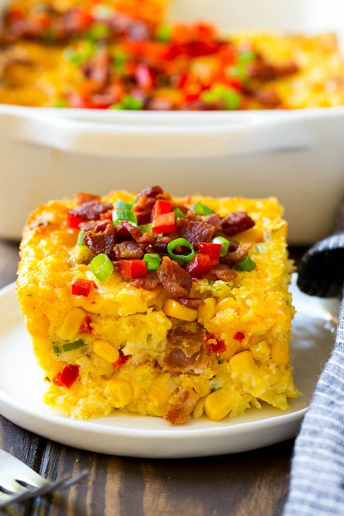 Loaded Corn Casserole Recipe | Easy Corn Casserole | Bacon Corn Casserole | Corn Pudding #corn #casserole #bacon #cheese #sidedish #thanksgiving #dinner #sadud A serving of corn casserole filled with bacon, cheese and peppers.