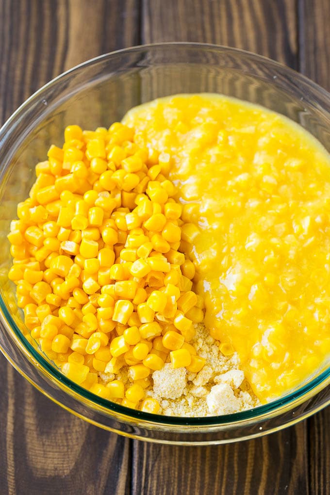 Loaded Corn Casserole Recipe | Easy Corn Casserole | Bacon Corn Casserole | Corn Pudding #corn #casserole #bacon #cheese #sidedish #thanksgiving #dinner #sadud Cornbread mix, corn and creamed corn in a mixing bowl.