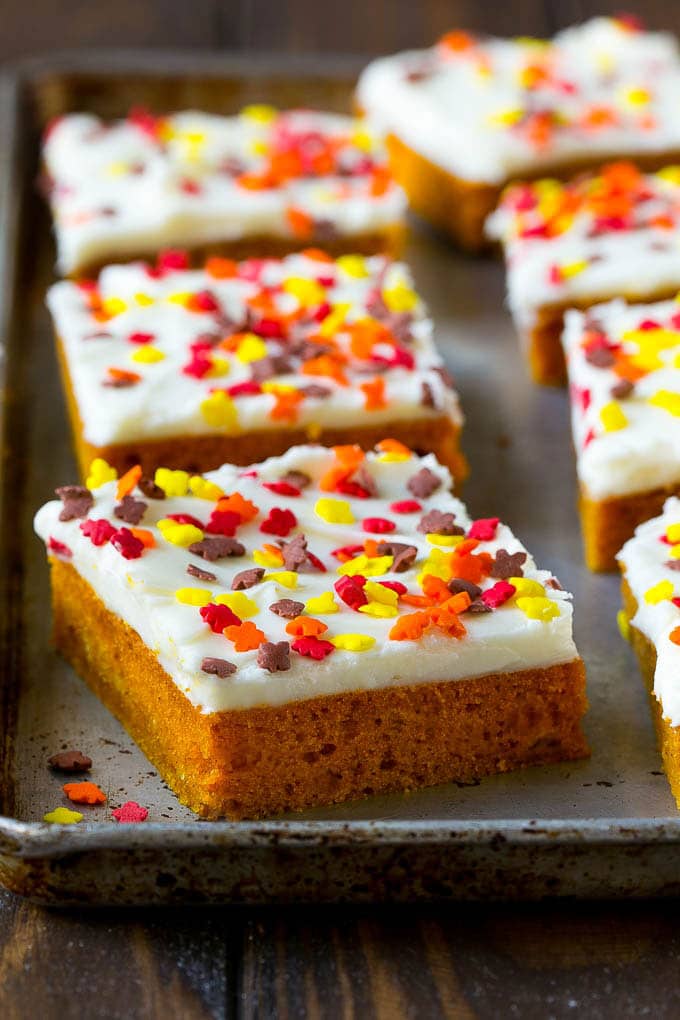 Pumpkin Bars Recipe | Pumpkin Cake | Pumpkin Dessert #pumpkin #fall #dessert #sadud #thanksgiving A baking sheet of frosted pumpkin bars.