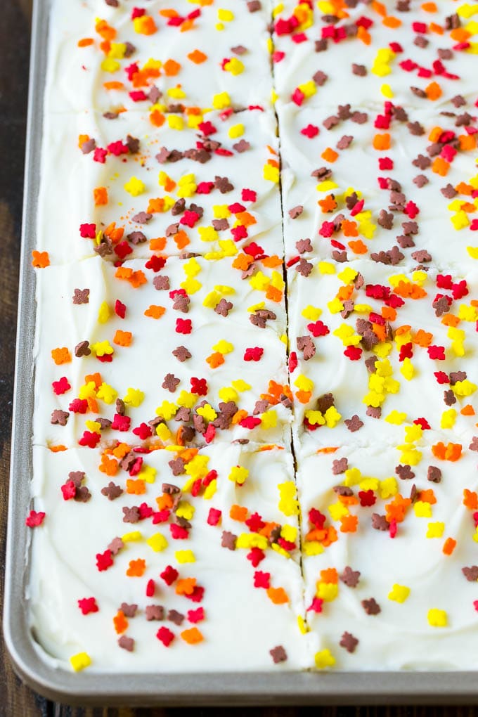 Pumpkin Bars Recipe | Pumpkin Cake | Pumpkin Dessert #pumpkin #fall #dessert #sadud #thanksgiving Cream cheese frosting and sprinkles spread over cake.
