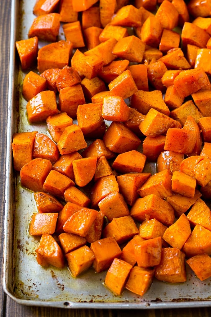 Maple Roasted Sweet Potatoes Recipe | Easy Sweet Potatoes | Baked Sweet Potatoes | Sweet Potato Side Dish #sweetpotatoes #cinnamon #maple #butter #fall #sidedish #dinner #sadud A sheet pan of roasted sweet potatoes.