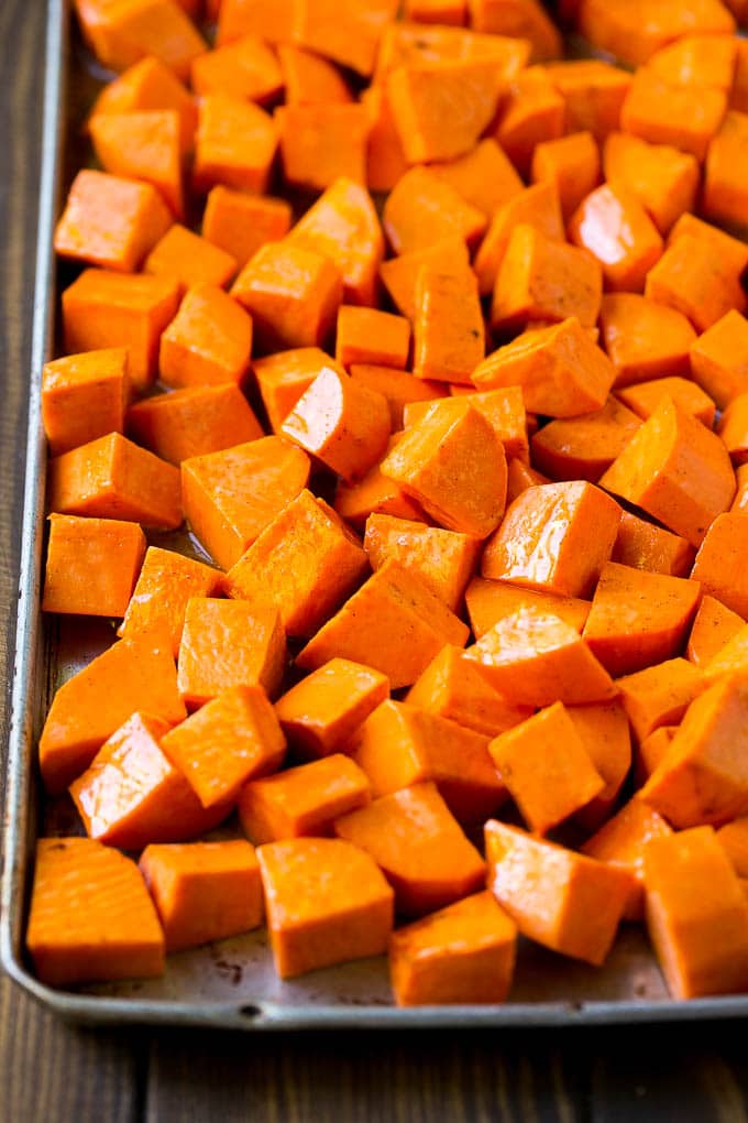 Maple Roasted Sweet Potatoes Recipe | Easy Sweet Potatoes | Baked Sweet Potatoes | Sweet Potato Side Dish #sweetpotatoes #cinnamon #maple #butter #fall #sidedish #dinner #sadud Raw diced sweet potatoes on a sheet pan, ready to go into the oven.