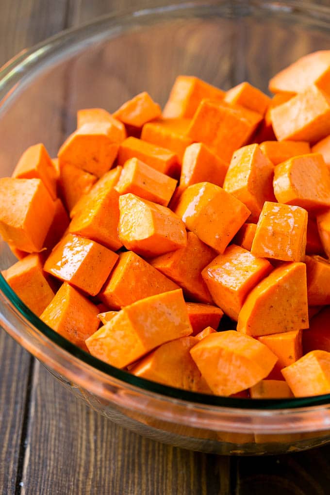 Maple Roasted Sweet Potatoes Recipe | Easy Sweet Potatoes | Baked Sweet Potatoes | Sweet Potato Side Dish #sweetpotatoes #cinnamon #maple #butter #fall #sidedish #dinner #sadud A bowl of peeled and diced yams.
