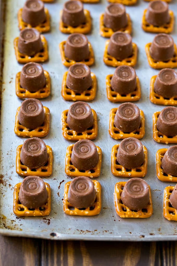 Rolo Pretzels Recipe | Chocolate Pretzels | Caramel Pretzels | Holiday Candy #christmas #baking #dessert #candy #chocolate #caramel #pretzels #sadud Squares with candies on top.