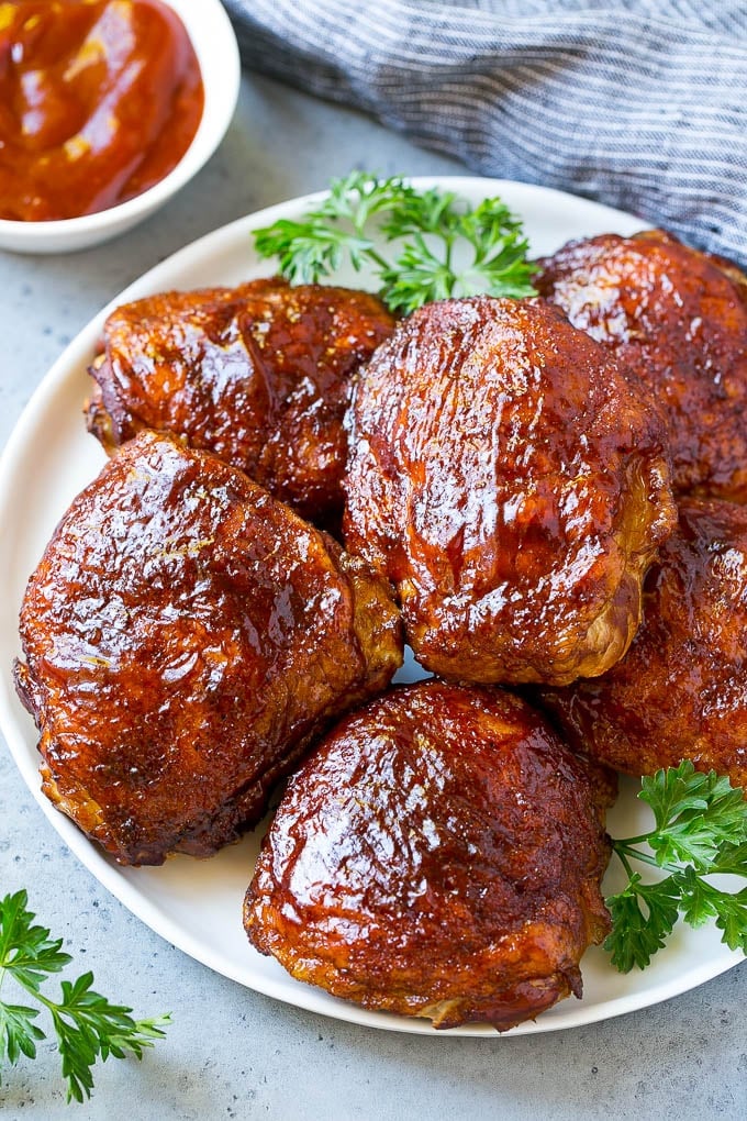 Smoked Chicken Thighs Recipe | Barbecue Chicken Thighs | Easy Chicken Thighs #chicken #barbecue #smoker #dinner #sadud A plate of smoked chicken thighs coated in spice rub and barbecue sauce.