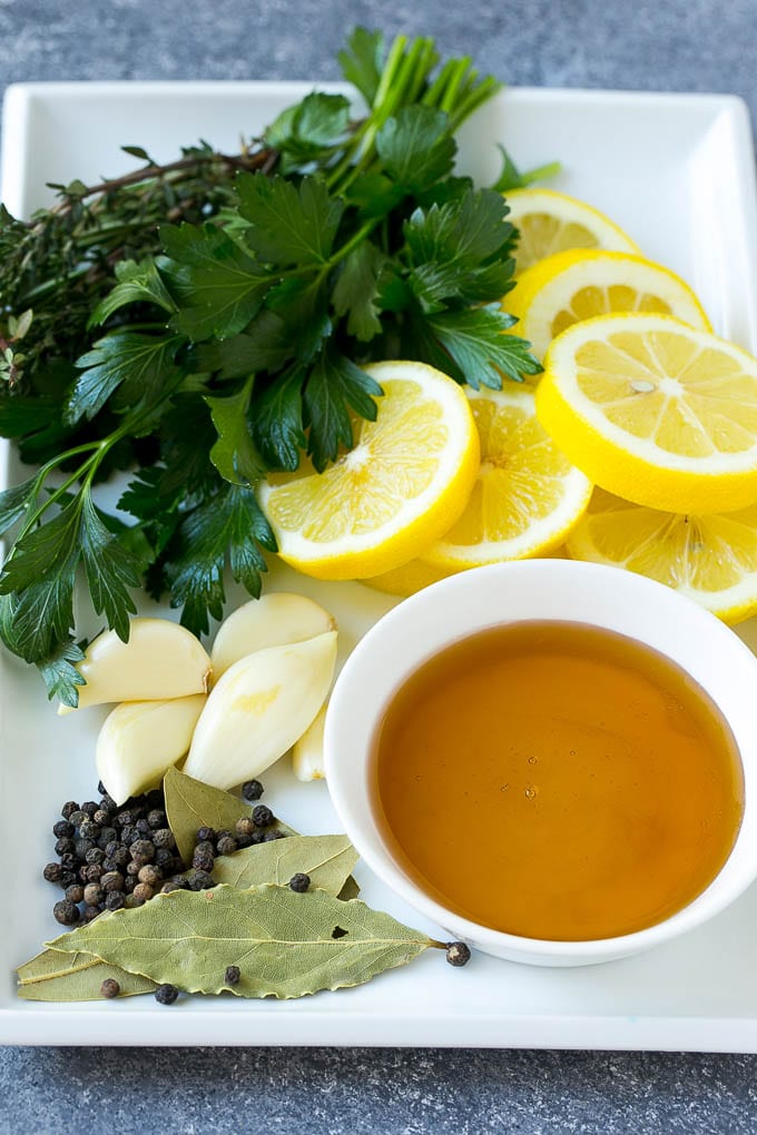 This chicken brine recipe is made with lemons, honey, fresh herbs and spices, and produces a juicy tender chicken every time! A foolproof way for succulent and flavorful roasted, smoked or fried chicken. Ingredients including honey, lemon, herbs, spices and garlic.