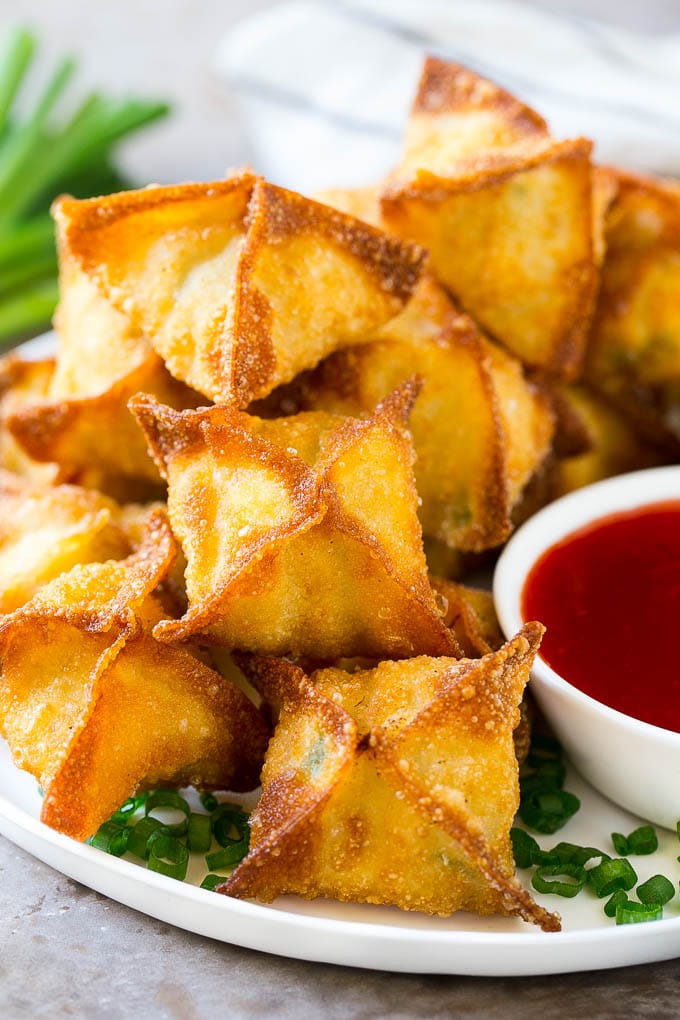 Crab Rangoon Recipe | Crab Wontons | Cream Cheese Wontons #crab #cheese #appetizer #snack #chinesefood #dinner #sadud A pile of crab rangoon wontons filled with a creamy crab mixture.