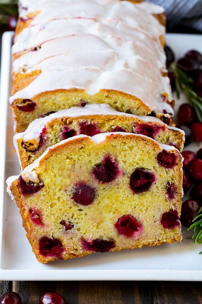 Cranberry Bread Recipe | Cranberry Loaf | Cranberry Orange Bread #cranberry #bread #baking #dessert #fall #sadud Slices of cranberry bread topped with orange glaze.