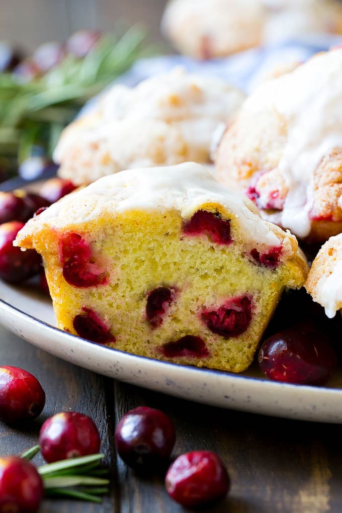 Cranberry Muffins Recipe | Cranberry Orange Muffins #cranberry #muffins #orange #fall #dessert #sadud A plate of muffins with one cut in half.