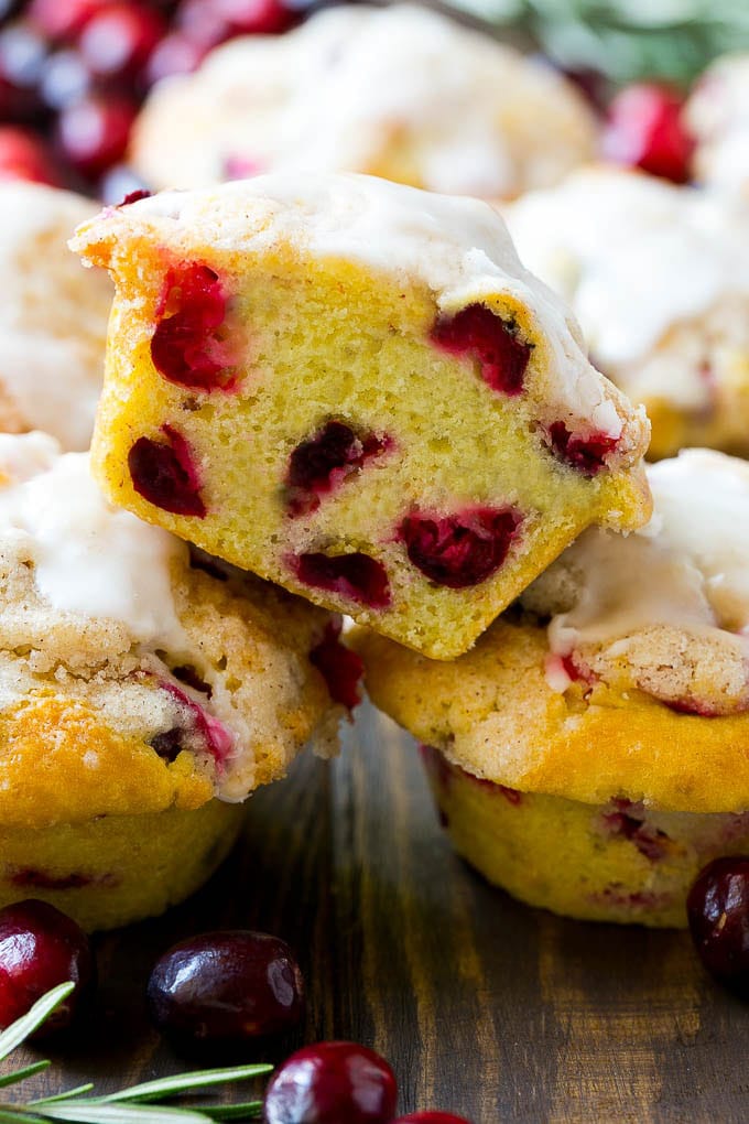 Cranberry Muffins Recipe | Cranberry Orange Muffins #cranberry #muffins #orange #fall #dessert #sadud A stack of cranberry muffins with one muffin cut in half.