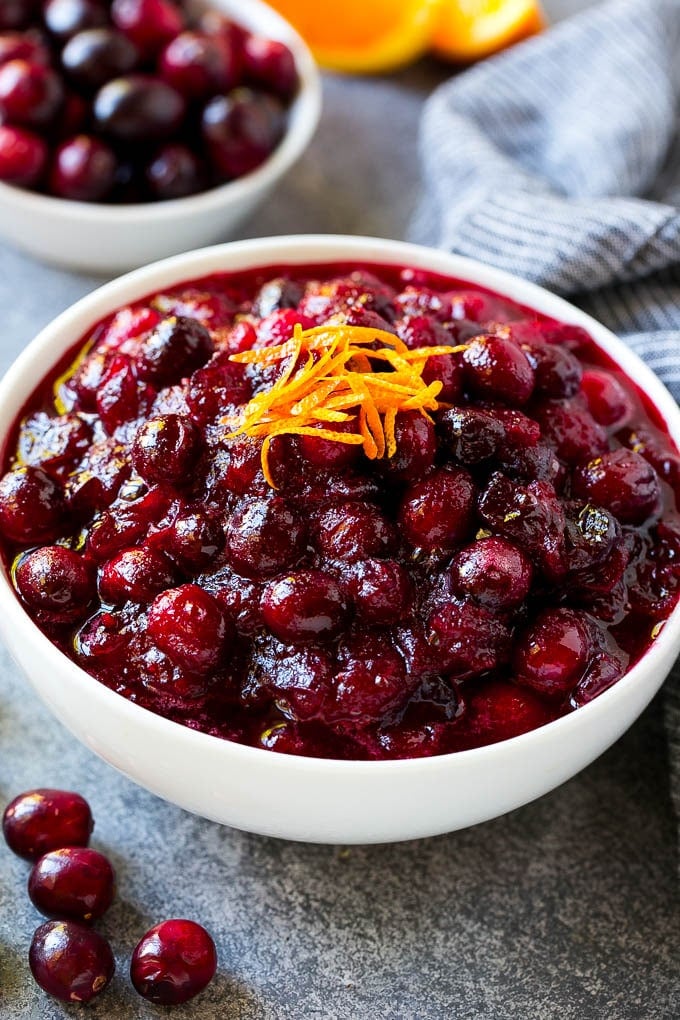 Cranberry Orange Sauce Recipe | Homemade Cranberry Sauce | Fresh Cranberry Sauce #cranberry #orange #fall #thanksgiving #sauce #dinner #sadud A bowl of cranberry orange sauce topped with fresh orange zest.