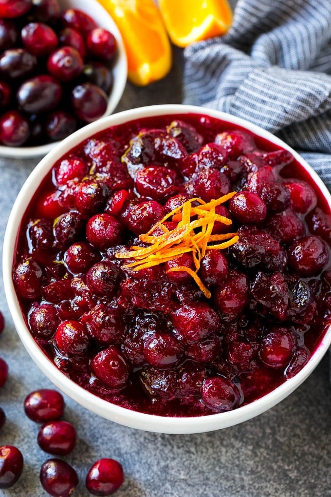 Cranberry Orange Sauce Recipe | Homemade Cranberry Sauce | Fresh Cranberry Sauce #cranberry #orange #fall #thanksgiving #sauce #dinner #sadud Cranberry orange sauce, topped with fresh orange zest in a serving bowl.