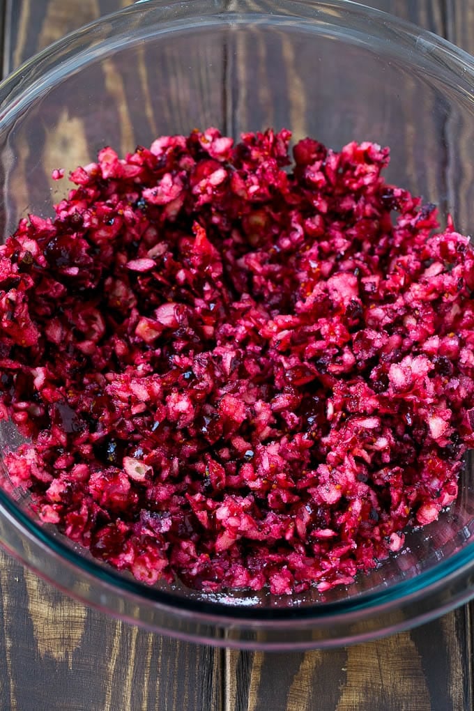 Cranberry Salad Recipe | Fluff Salad #cranberry #salad #fall #dinner #sadud #thanksgiving Chopped cranberries mixed with sugar in a bowl.