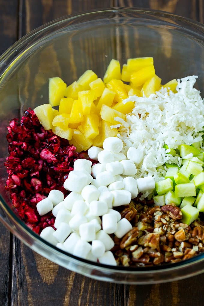 Cranberry Salad Recipe | Fluff Salad #cranberry #salad #fall #dinner #sadud #thanksgiving Chopped cranberries, apples, pineapple, marshmallows, pecans and coconut in a mixing bowl.