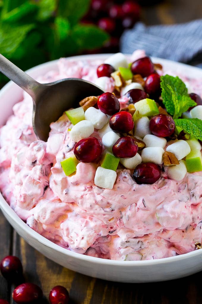 Cranberry Salad Recipe | Fluff Salad #cranberry #salad #fall #dinner #sadud #thanksgiving Cranberry salad with a serving spoon in it.