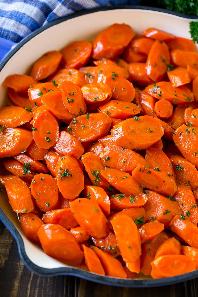 Glazed Carrots Recipe | Brown Sugar Carrots | Carrot Side Dish #carrots #brownsugar #sidedish #glutenfree #thanksgiving #fall #dinner #sadud A skillet of glazed carrots with brown sugar and butter sauce.