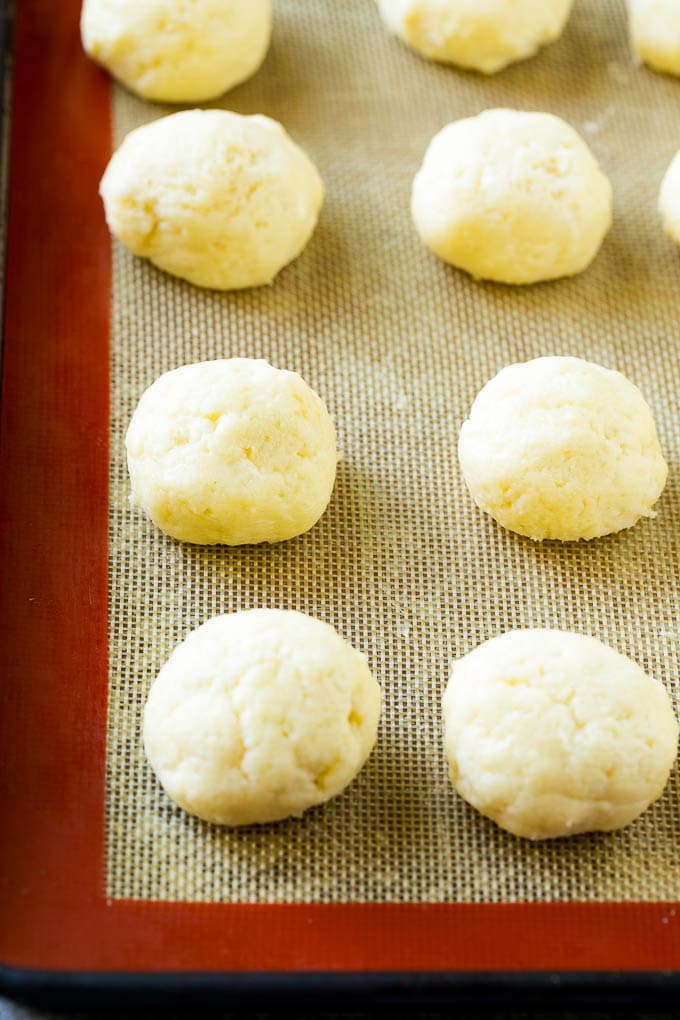 Gooey Butter Cookies Recipe | Cake Mix Cookies | Sprinkle Cookies | Christmas Cookies #cookies #butter #sprinkles #christmas #dessert #baking #sadud Balls of dough on a baking sheet.