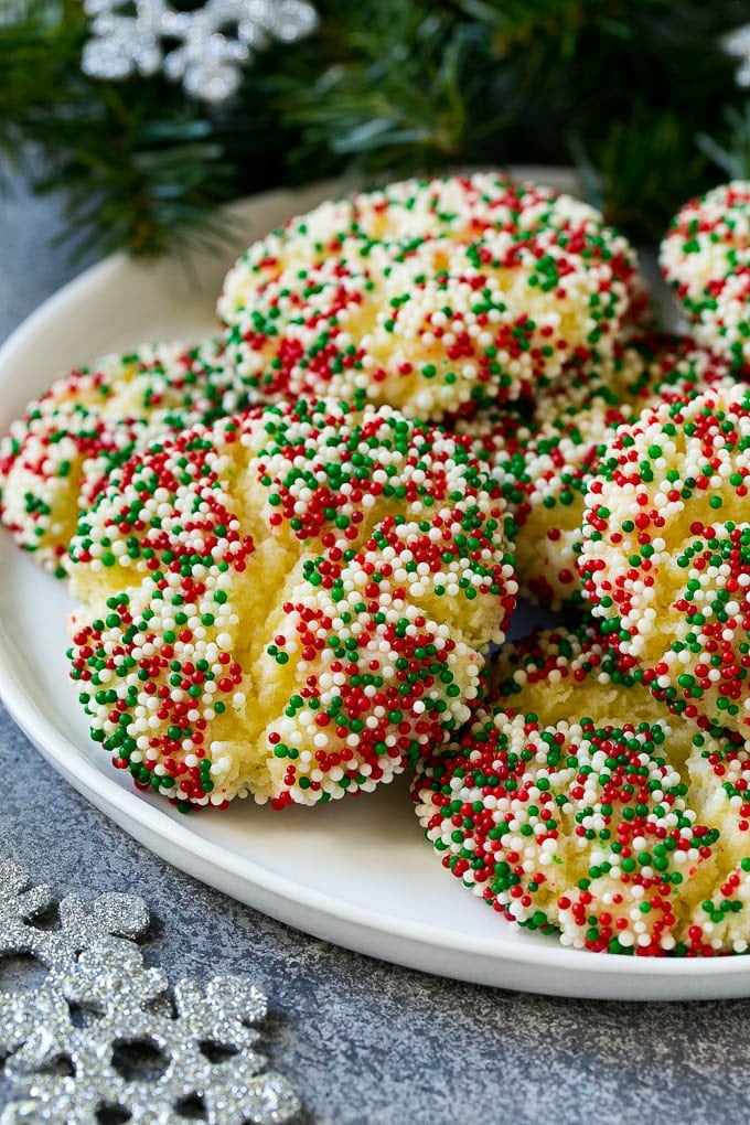 Gooey Butter Cookies Recipe | Cake Mix Cookies | Sprinkle Cookies | Christmas Cookies #cookies #butter #sprinkles #christmas #dessert #baking #sadud A plate of gooey butter cookies covered in holiday sprinkles.