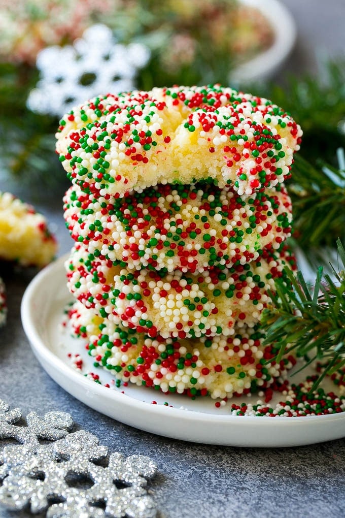 Gooey Butter Cookies Recipe | Cake Mix Cookies | Sprinkle Cookies | Christmas Cookies #cookies #butter #sprinkles #christmas #dessert #baking #sadud A stack of gooey butter cookies with a bite taken out of one.