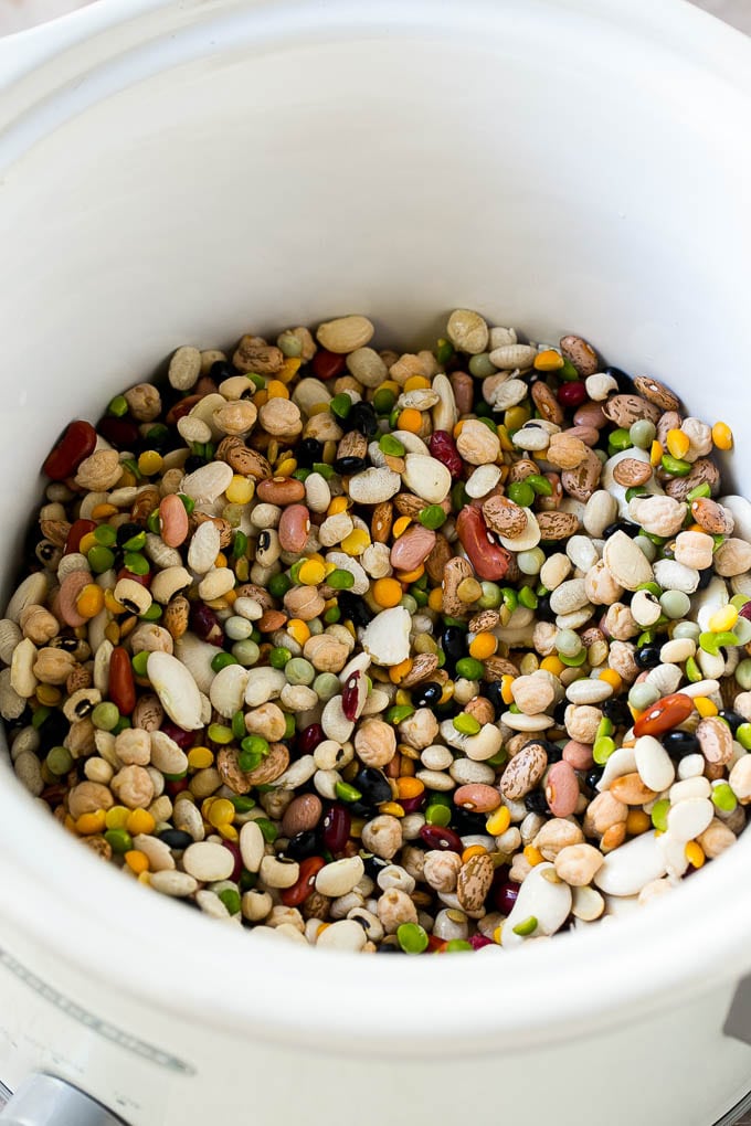 Ham and Bean Soup Recipe | Slow Cooker Ham and Bean Soup | Crockpot Ham and Bean Soup | Leftover Ham Recipe #ham #beans #soup #slowcooker #crockpot #dinner #sadud A mixture of dried beans in a crock pot.