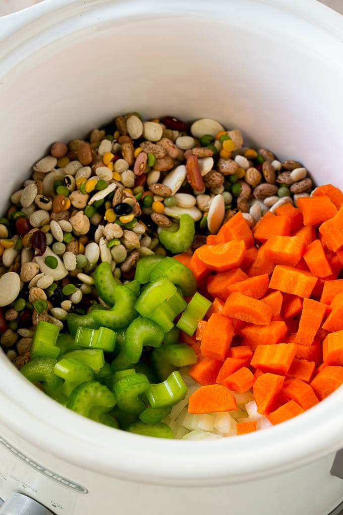 Ham and Bean Soup Recipe | Slow Cooker Ham and Bean Soup | Crockpot Ham and Bean Soup | Leftover Ham Recipe #ham #beans #soup #slowcooker #crockpot #dinner #sadud Dried beans, carrots, onions and celery in the slow cooker.