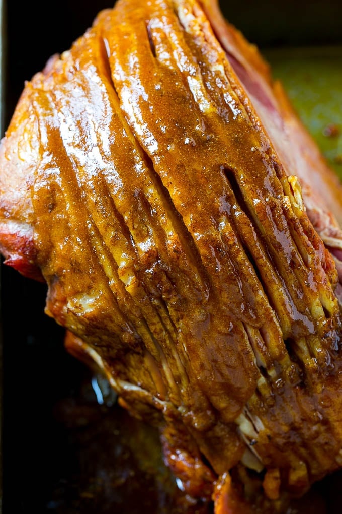 Honey Baked Ham Recipe | Glazed Ham | Holiday Ham #ham #dinner #sadud #christmas #thanksgiving #easter A ham coated in sugar glaze in a baking pan.