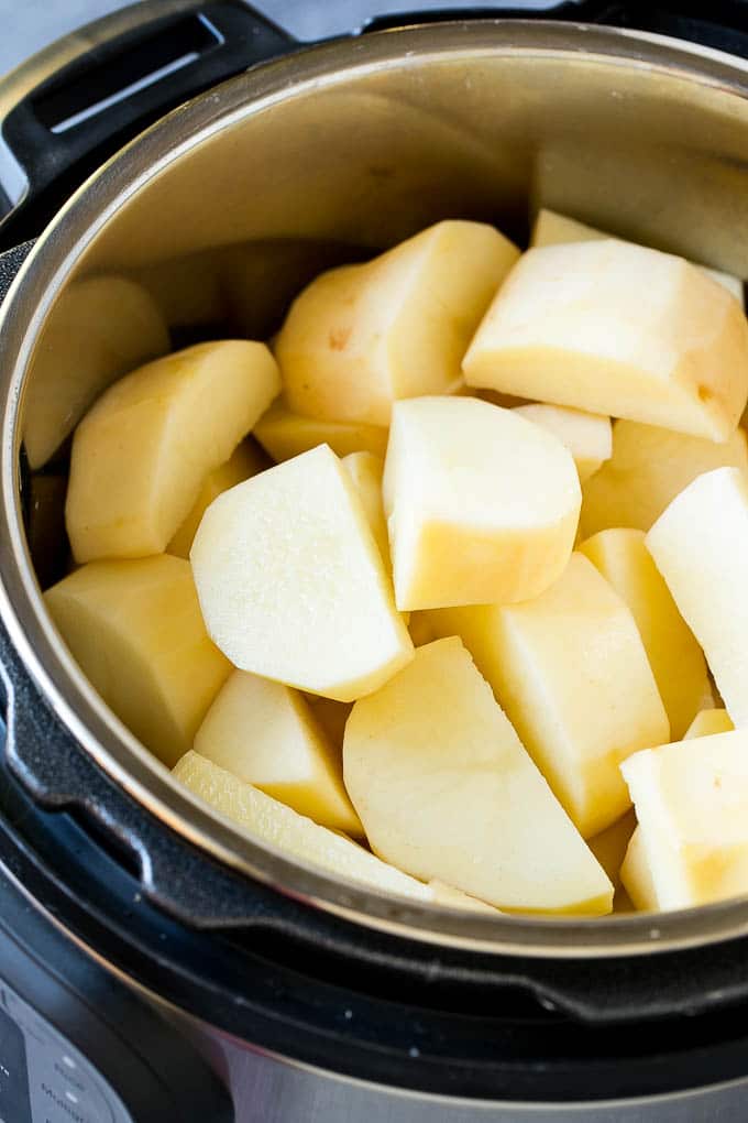 Instant Pot Mashed Potatoes Recipe | Pressure Cooker Mashed Potatoes | Easy Mashed Potatoes #potatoes #sidedish #instantpot #thanksgiving #dinner #sadud Peeled potatoes in an Instant Pot.