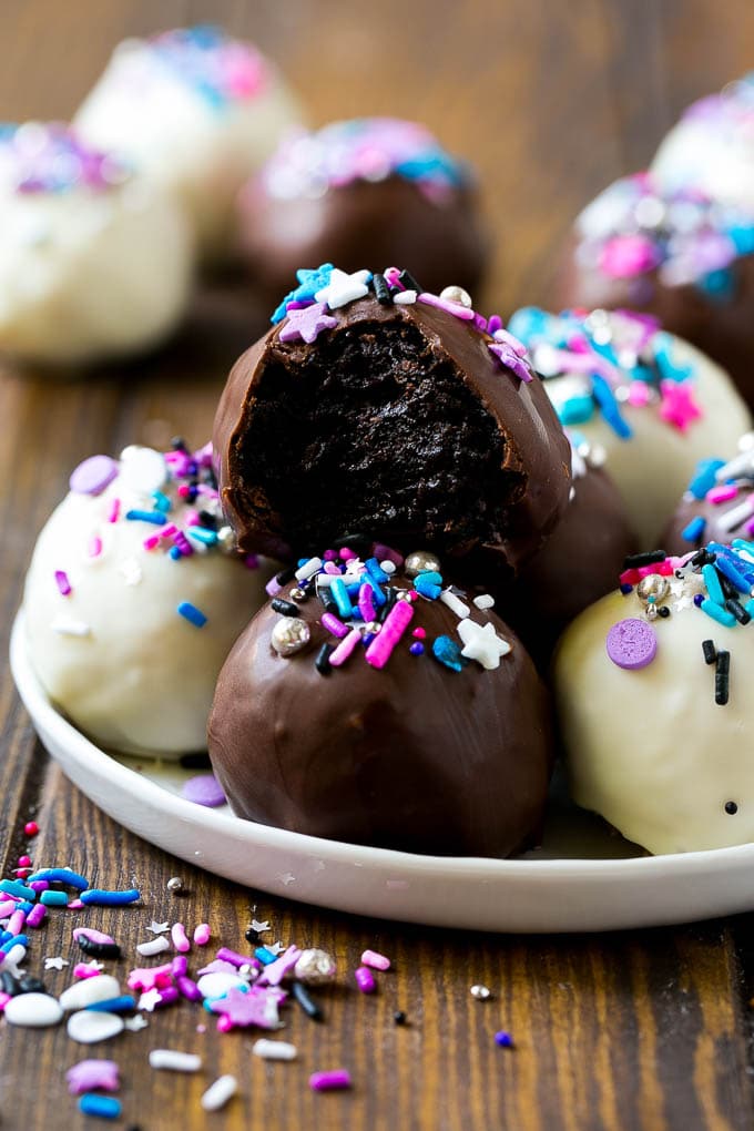 Oreo Balls Recipe | Oreo Truffles | Homemade Candy #truffles #candy #oreos #chocolate #sprinkles #dessert #christmas #sadud A plate of dark and white chocolate Oreo balls topped with colorful sprinkles.