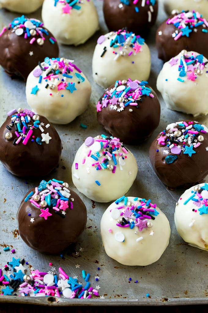 Oreo Balls Recipe | Oreo Truffles | Homemade Candy #truffles #candy #oreos #chocolate #sprinkles #dessert #christmas #sadud Assorted colors of Oreo balls on a sheet pan.