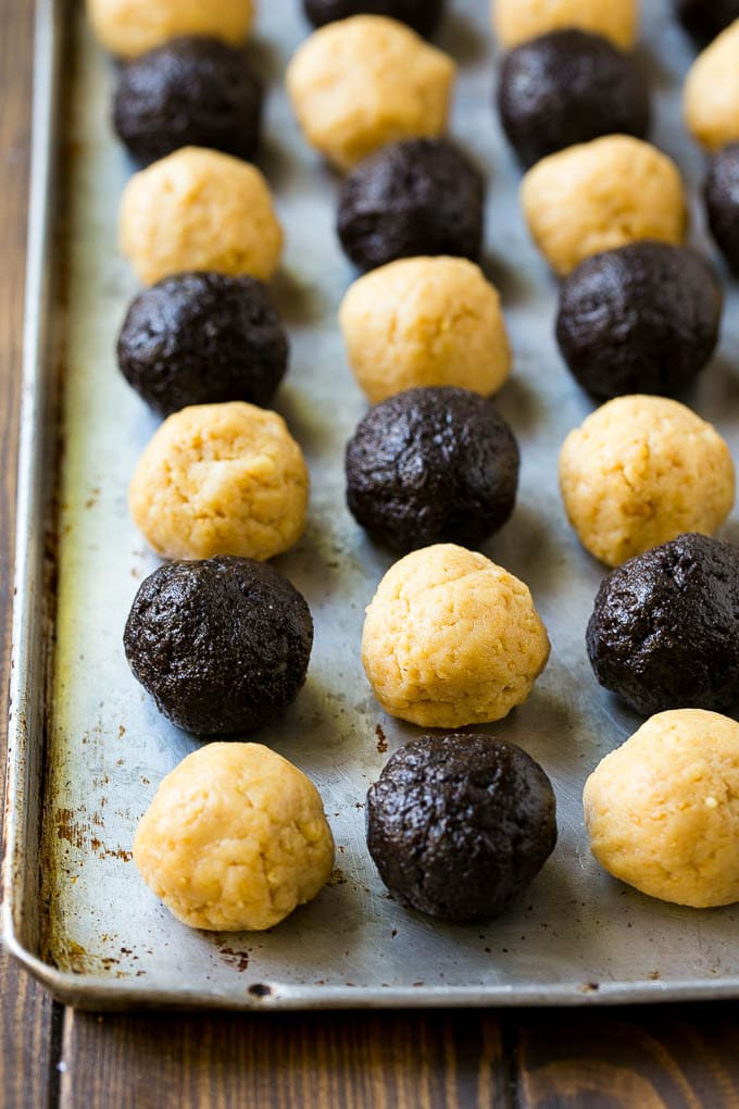 Oreo Balls Recipe | Oreo Truffles | Homemade Candy #truffles #candy #oreos #chocolate #sprinkles #dessert #christmas #sadud Oreo ball centers made from vanilla and chocolate Oreos on a sheet pan.