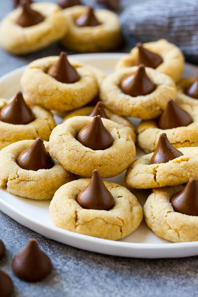 Peanut Butter Blossoms Recipe | Hershey Kiss Cookies | Chocolate Peanut Butter Cookies #cookies #peanutbutter #chocolate #dessert #baking #christmas #christmascookies #sadud A serving plate of peanut butter blossoms.