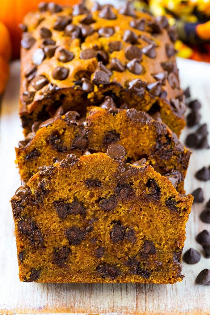 Pumpkin Chocolate Chip Bread Recipe | Pumpkin Bread | Chocolate Pumpkin Bread #pumpkin #bread #fall #chocolate #baking #dessert #sadud Sliced pumpkin chocolate chip bread on a serving board.