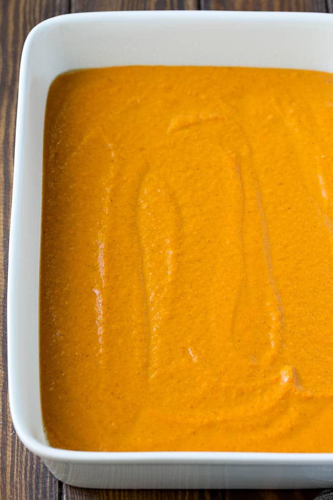 Pumpkin Dump Cake Recipe | Pumpkin Cake | Pumpkin Pie Cake #pumpkin #cake #pecans #fall #thanksgiving #dessert #sadud Pumpkin pie filling poured into a baking dish.