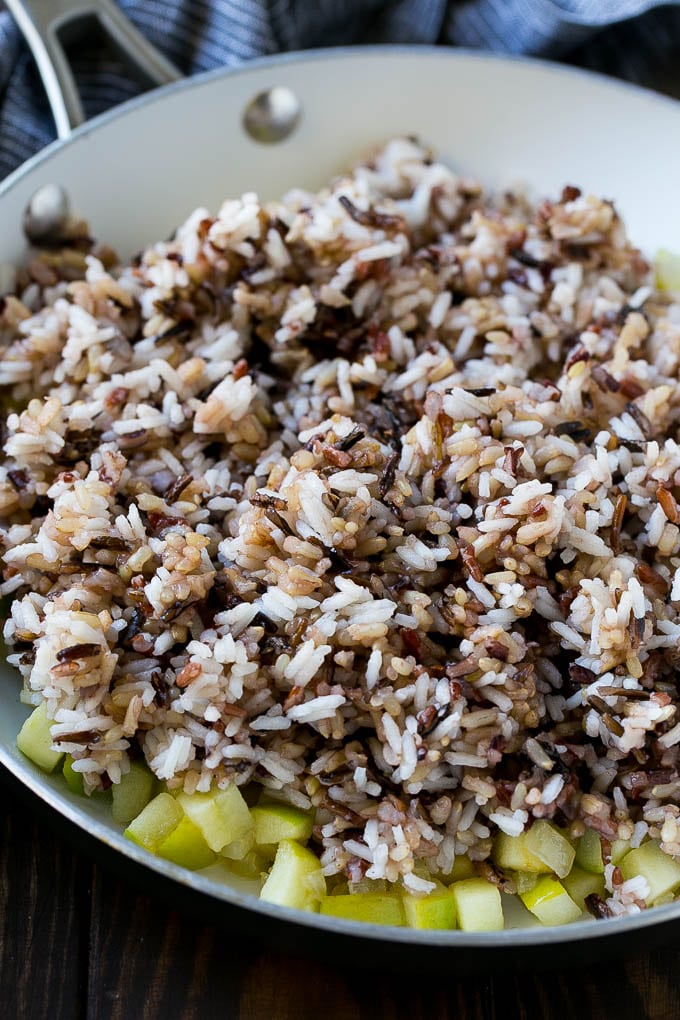 Wild Rice Pilaf Recipe | Thanksgiving Side Dish | Rice Pilaf #rice #apple #cranberry #fall #glutenfree #thanksgiving #sadud WIld rice, onions and apples in a skillet.