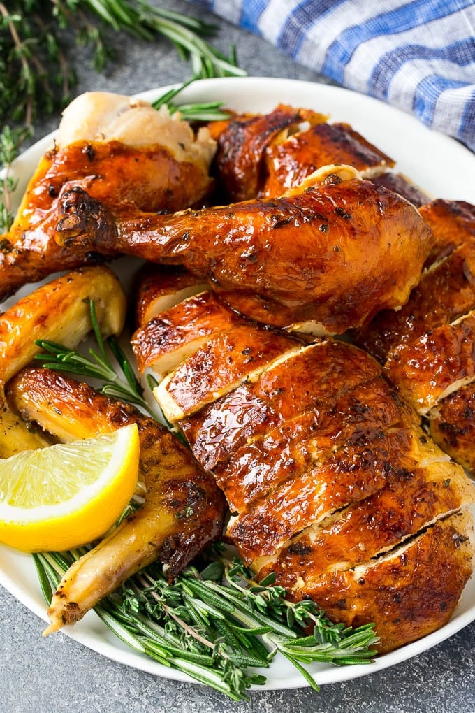 Roasted Chicken Recipe | Whole Roasted Chicken | Roast Chicken #chicken #dinner #lowcarb #keto #sadud Carved roasted chicken on a serving platter with fresh herbs.