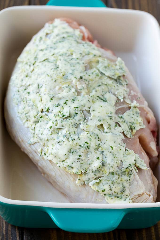 This roasted turkey breast is coated in a savory garlic and herb butter, then baked to golden brown perfection. A turkey breast coated with garlic and herb butter.